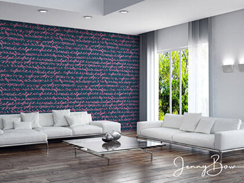 Image of a modern living room with a sleek white sofa and large windows. The wall behind the sofa is dark blue with an asemic text style design in stripes. Wallcovering designed by Jenny Bova