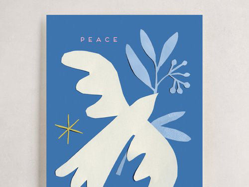 Image of a holiday card with a white cutout dove holding a cutout blue olive branch on a dark blue background