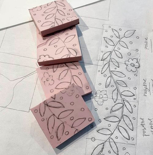 uncarved rubber stamps next to sketch showing leaves and flower line drawing on tracing paper