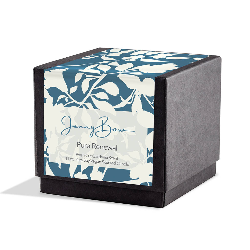 Square black candle box with a label covering the front and top. The label is a deep aqua and white floral design. On the front are the Jenny Bova logo, the name of the candle, "Pure Renewal,” and product details. The background is white. 