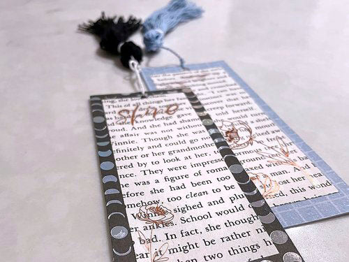 image of two handmade bookmarks with text, layers, and tassels