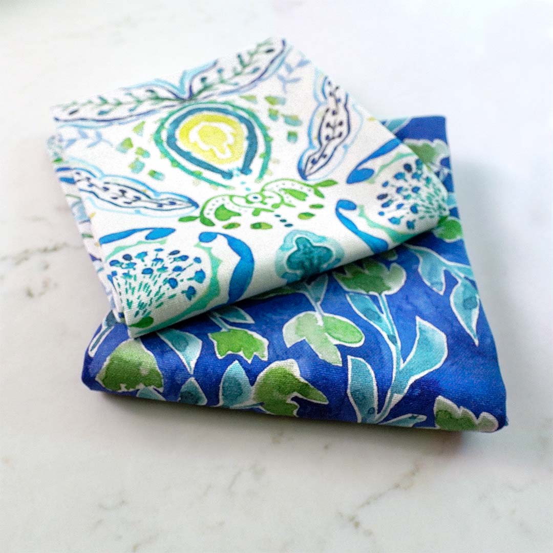 folded watercolor pattern tea towels in blues and greens