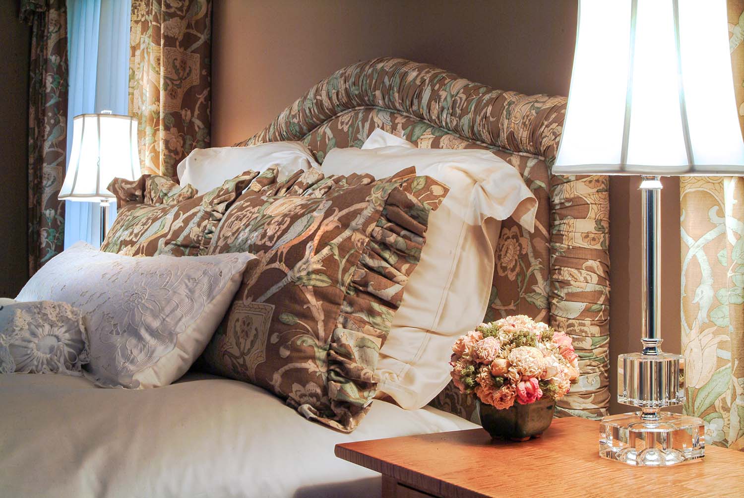 headboard and pillows with brown floral and bird fabric