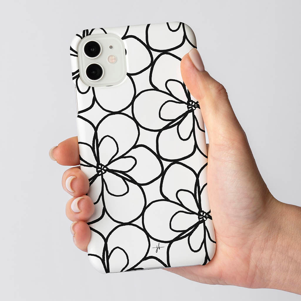 black and white floral iphone case in a womans hand
