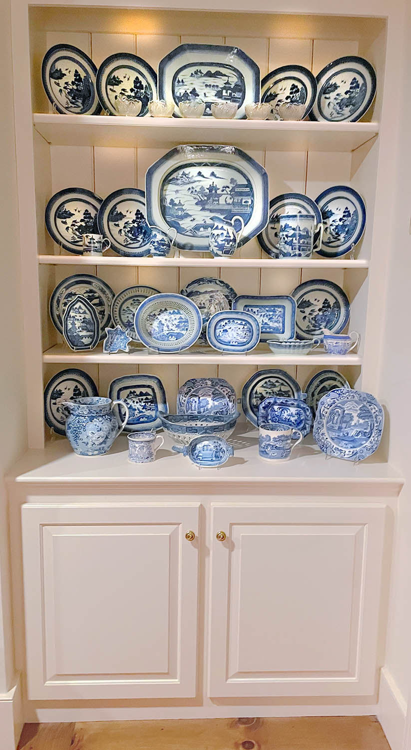 blue and white canton on a white built in shelf
