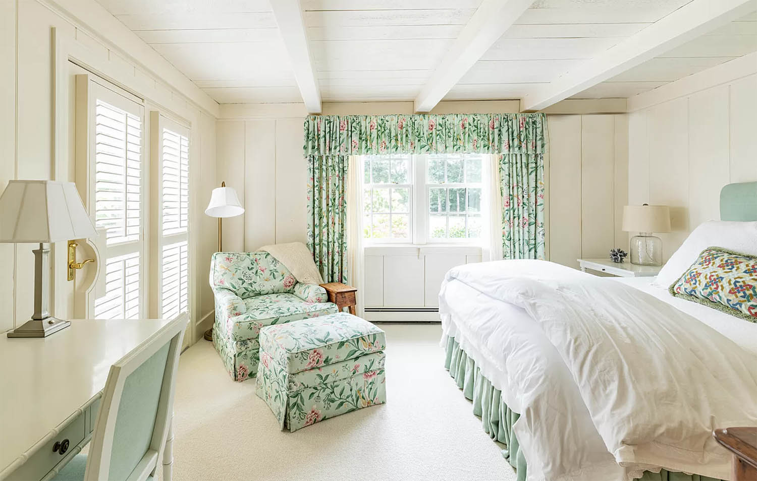 coastal bedroom with white walls and aqua english fabric 