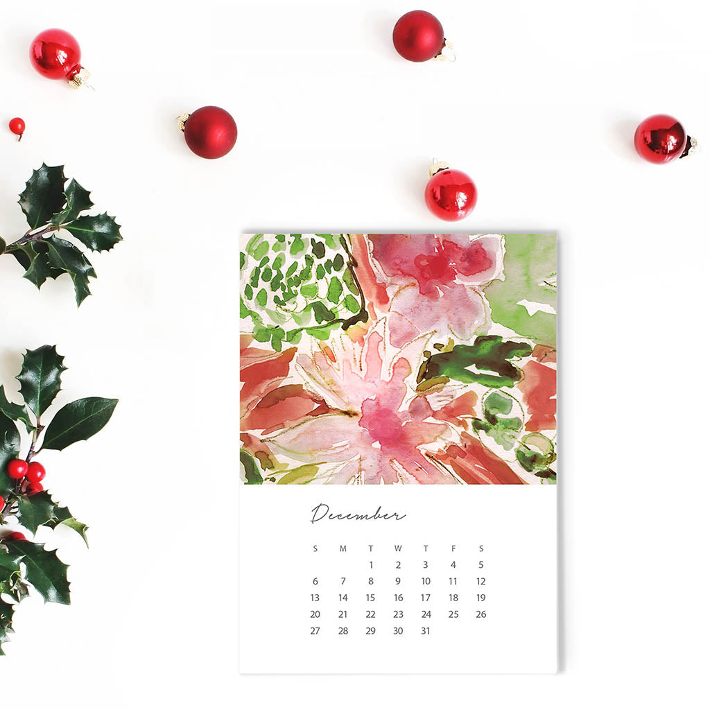 Calendar for December with floral design and Christmas decorations on a white background