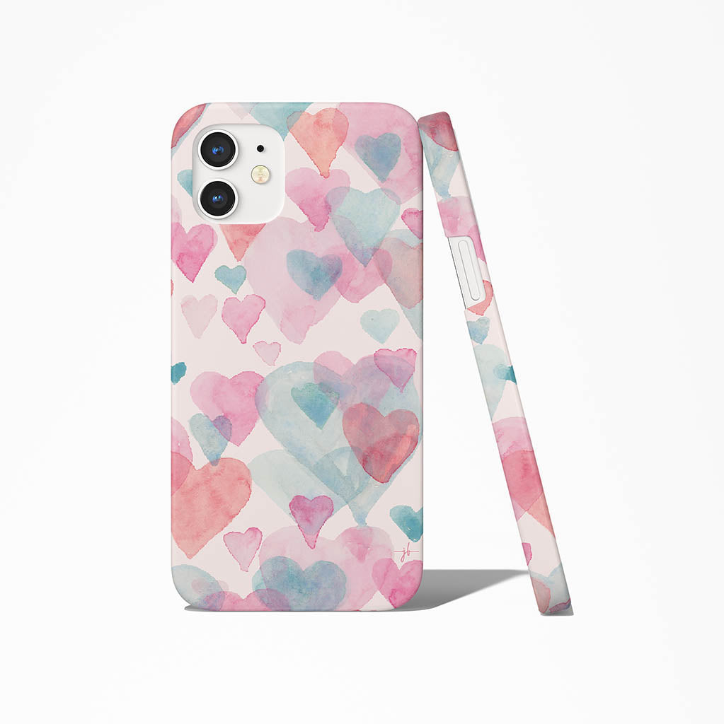iPhone case with pattern of blue pink and red heats on pink background