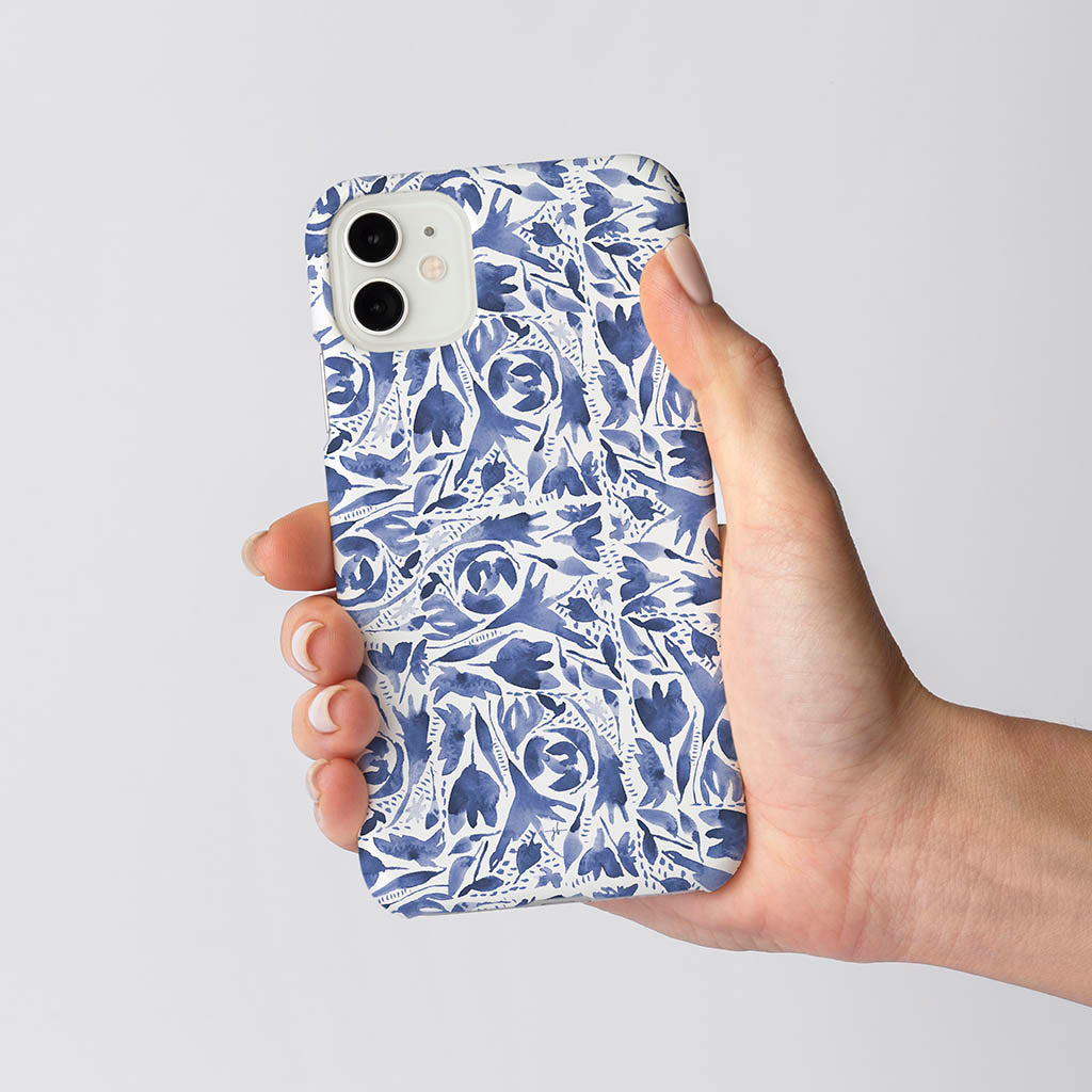 watercolor repeat pattern folk floral in blue and white on iphone case in woman&#39;s hand