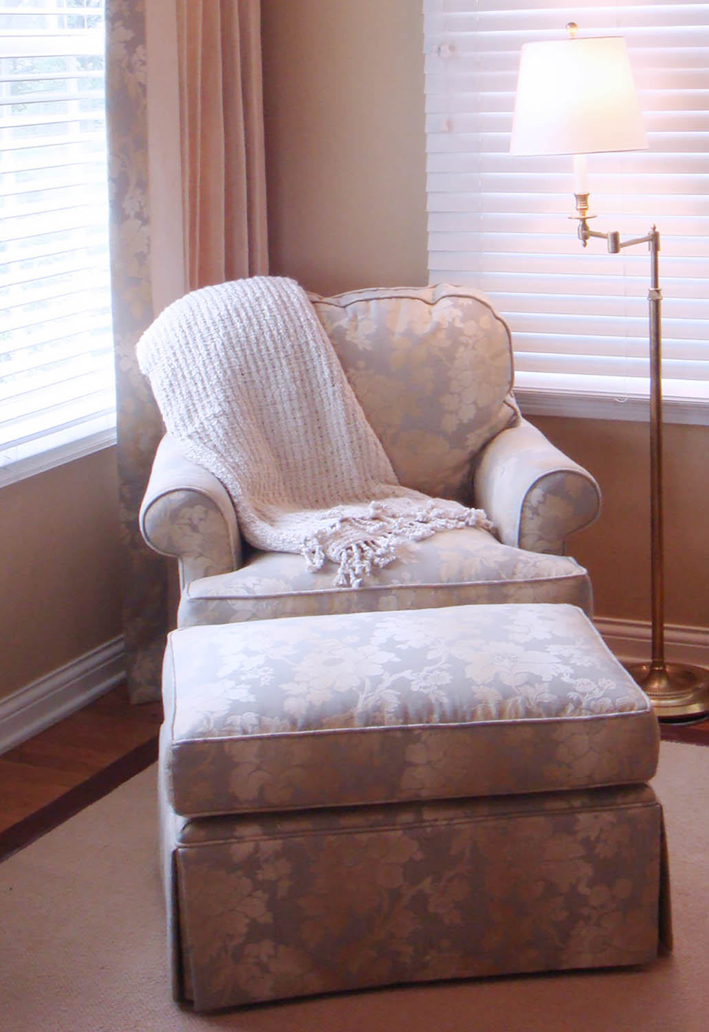 sitting area with chair and throw