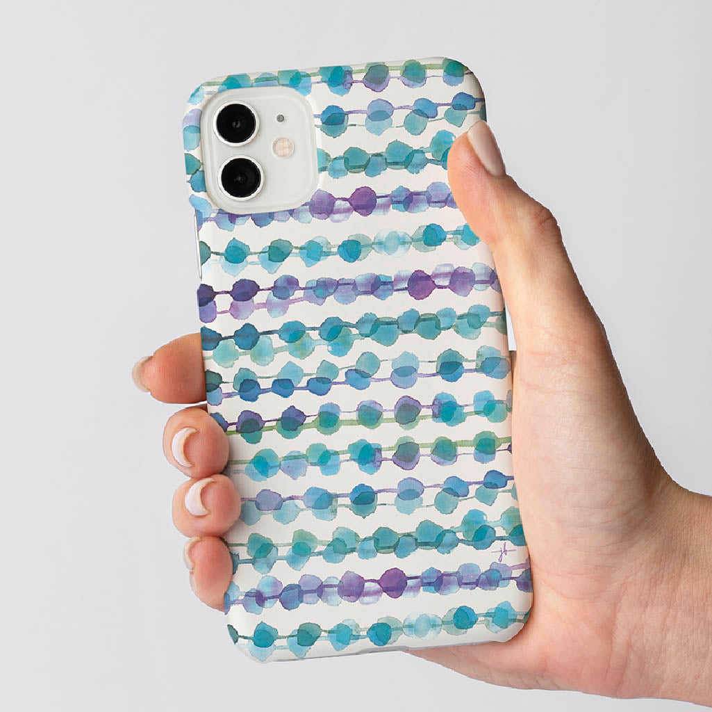 watercolor geometric circle design on iPhone case in woman&#39;s hand