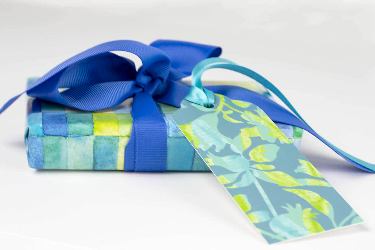 gift wrapped with Jenny Bova&#39;s watercolor gift wrap, a blue ribbon, and a matching gift tag